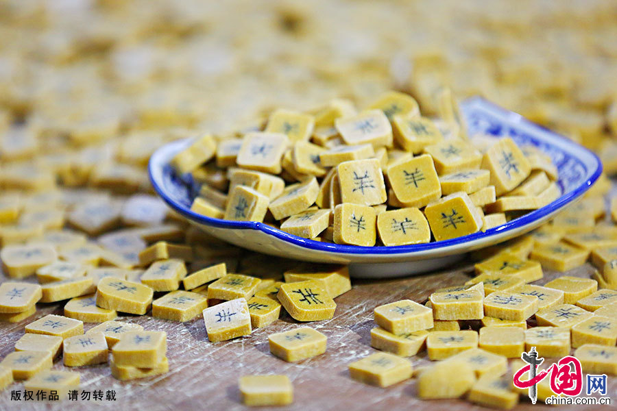 字豆糖由麦芽糖稀、黑芝麻粉、黄豆粉三种原生态的材料组成,经过制糖艺人巧妙制作,在切开的每块糖片中,都会蕴藏着一个吉祥如意的汉字,是一种可食可赏的民间糕点。中国网图片库 施亚磊/摄 字豆糖由麦芽糖稀、黑芝麻粉、黄豆粉三种原生态的材料组成,经过制糖艺人巧妙制作,在切开的每块糖片中,都会蕴藏着一个吉祥如意的汉字,是一种可食可赏的民间糕点。中国网图片库 施亚磊/摄